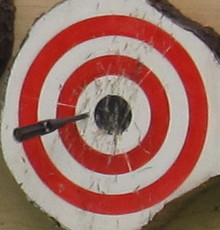 Spray painted EuroThrowers target, with Gyro Dart throwing knife sticking.