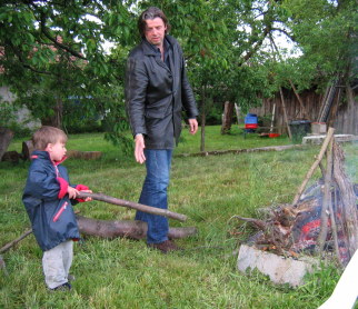 The neighbour's boys help to get the fire going.